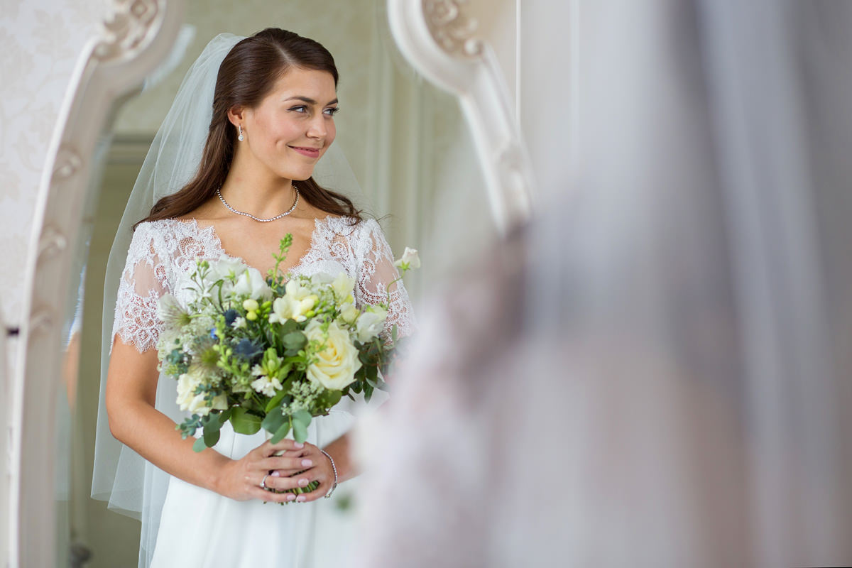 bride reflected in mirror in hedsor house bridal suite