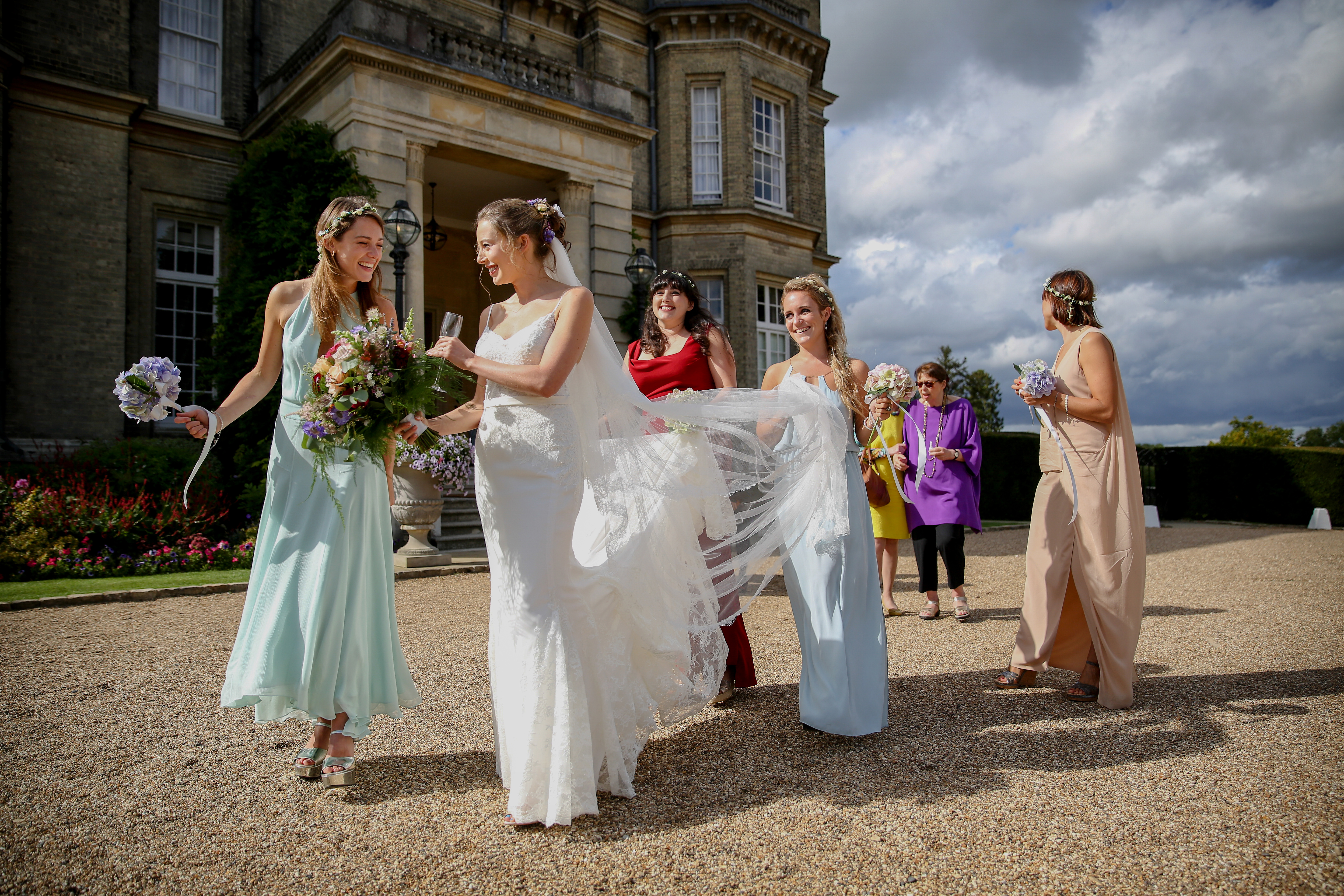 bride and bridesmaids walking away from hedsor house after ceremony